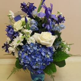 Blue and white floral arrangement in a patterned vase