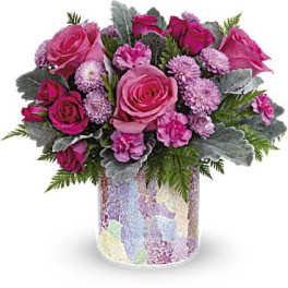 Pink roses and small purple flowers in a patterned vase