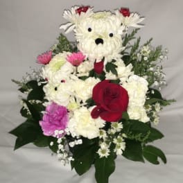 Playful dog-shaped flower arrangement in white blooms with a red rose and pink accents