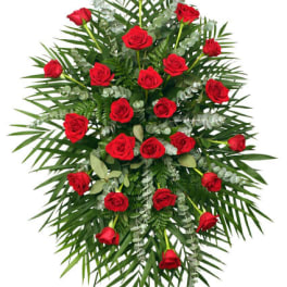 Standing spray of red roses with palm fronds and eucalyptus