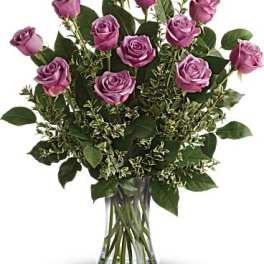 Bouquet of purple roses in a clear glass vase