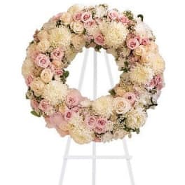 Pastel floral wreath on a white stand