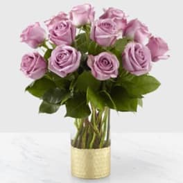 Bouquet of lavender roses in a gold vase