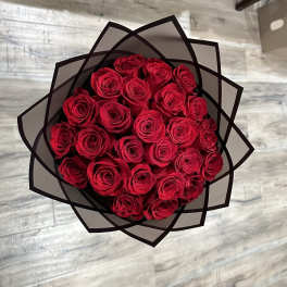 Bouquet of red roses wrapped in black paper