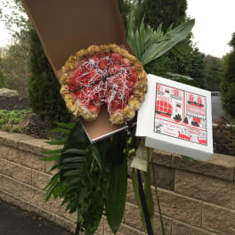 Large floral standing spray with red and gold flowers on an easel