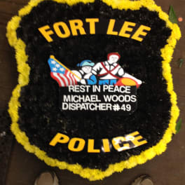 Black and yellow funeral wreath with police tribute lettering