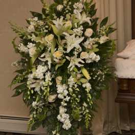 Large white floral standing spray with lilies and roses