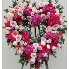 Heart-shaped floral wreath with pink roses and gerbera daisies