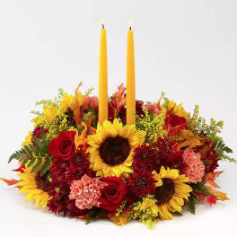 Autumn floral centerpiece with two yellow candles
