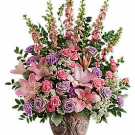 Pink and lavender floral arrangement in a decorative vase