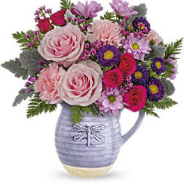 Mixed pink and purple bouquet in a lavender pitcher vase