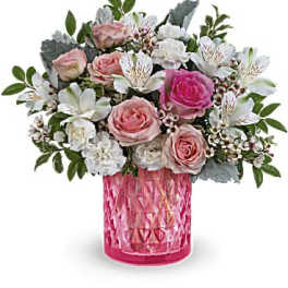 Pink and white rose bouquet in a textured pink vase