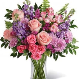 Pink and purple bouquet in a clear glass vase