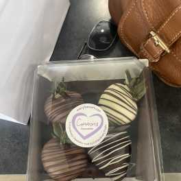 Box of chocolate-covered strawberries in a clear plastic container