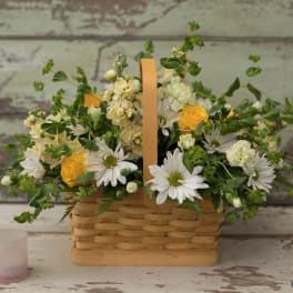 Basket arrangement with white daisies and yellow roses