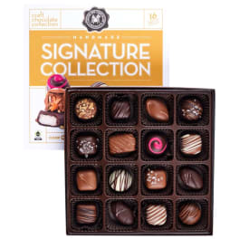 Box of assorted chocolates with a branded gift box behind it
