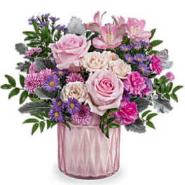 Pink and purple flower arrangement in a glass vase