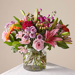 Mixed pink and purple bouquet in a clear glass vase