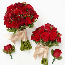 Two red rose bouquets with matching boutonnieres on a white background