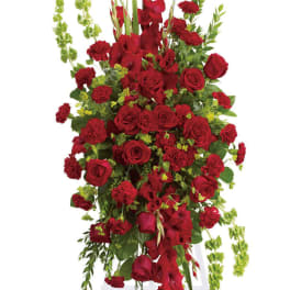 Tall red floral spray with roses and carnations on a white stand