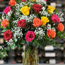 Mixed roses in a glass vase with baby's breath