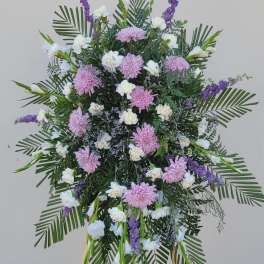 Large standing floral spray with pink and white blooms on an easel