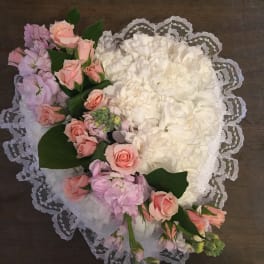 Heart-shaped bouquet of white and pink flowers with lace trim