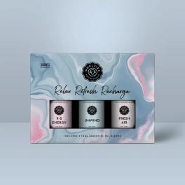 Boxed set of three essential oil blends on a blue and pink marbled background.