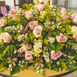 Large low floral arrangement with pale pink roses and white filler flowers