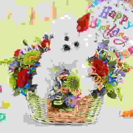 White teddy bear in a basket with colorful gift items