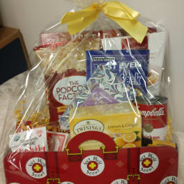 Get Well Soon gift basket with snacks and tea wrapped in clear cellophane