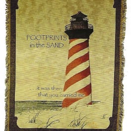 Decorative blanket with a lighthouse and the words "Footprints in the Sand"