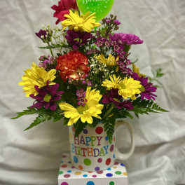 Birthday flower arrangement in a mug with a balloon and gift box