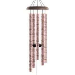 Hanging wind chime with pink tubes and a brown top and weight