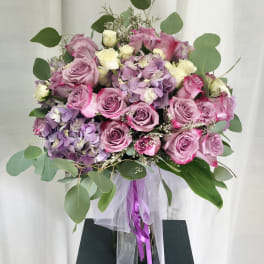 Bouquet of pink and lavender roses with hydrangeas and eucalyptus