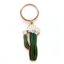 Cactus-shaped keychain with white flower accents