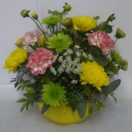 Bouquet of yellow and pink flowers in a yellow vase