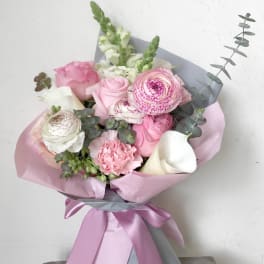 Pink and white bouquet with roses, ranunculus, calla lilies, and snapdragons