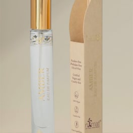 A perfume bottle with a gold cap beside its beige box