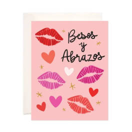 Pink greeting card with lips, hearts, and "Besos y Abrazos" text