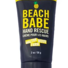 Black tube of Beach Babe hand rescue cream with yellow text