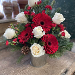 Red gerberas and white roses in a metal vase