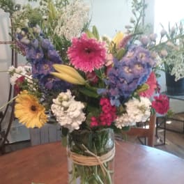 Mixed bouquet of colorful flowers in a clear glass vase