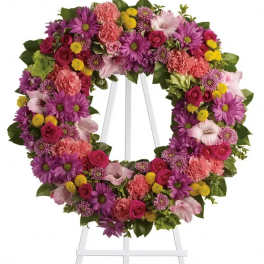 Colorful floral wreath on a white easel