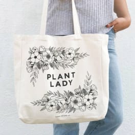 Canvas tote bag with floral line art and the words "PLANT LADY"