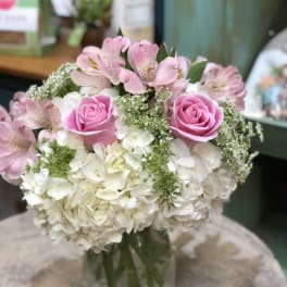 Pink roses and white hydrangeas in a glass vase
