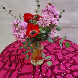 Pink and red flowers arranged in a glass vase