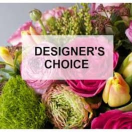 Bright mixed bouquet of pink and yellow flowers with text reading Designer's Choice