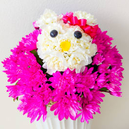 Pink chrysanthemum arrangement shaped like a bird with a red bow