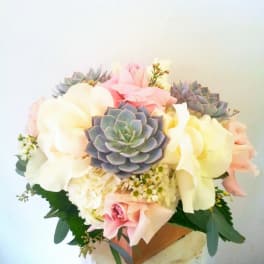 Bouquet of pastel roses and succulents in a vase